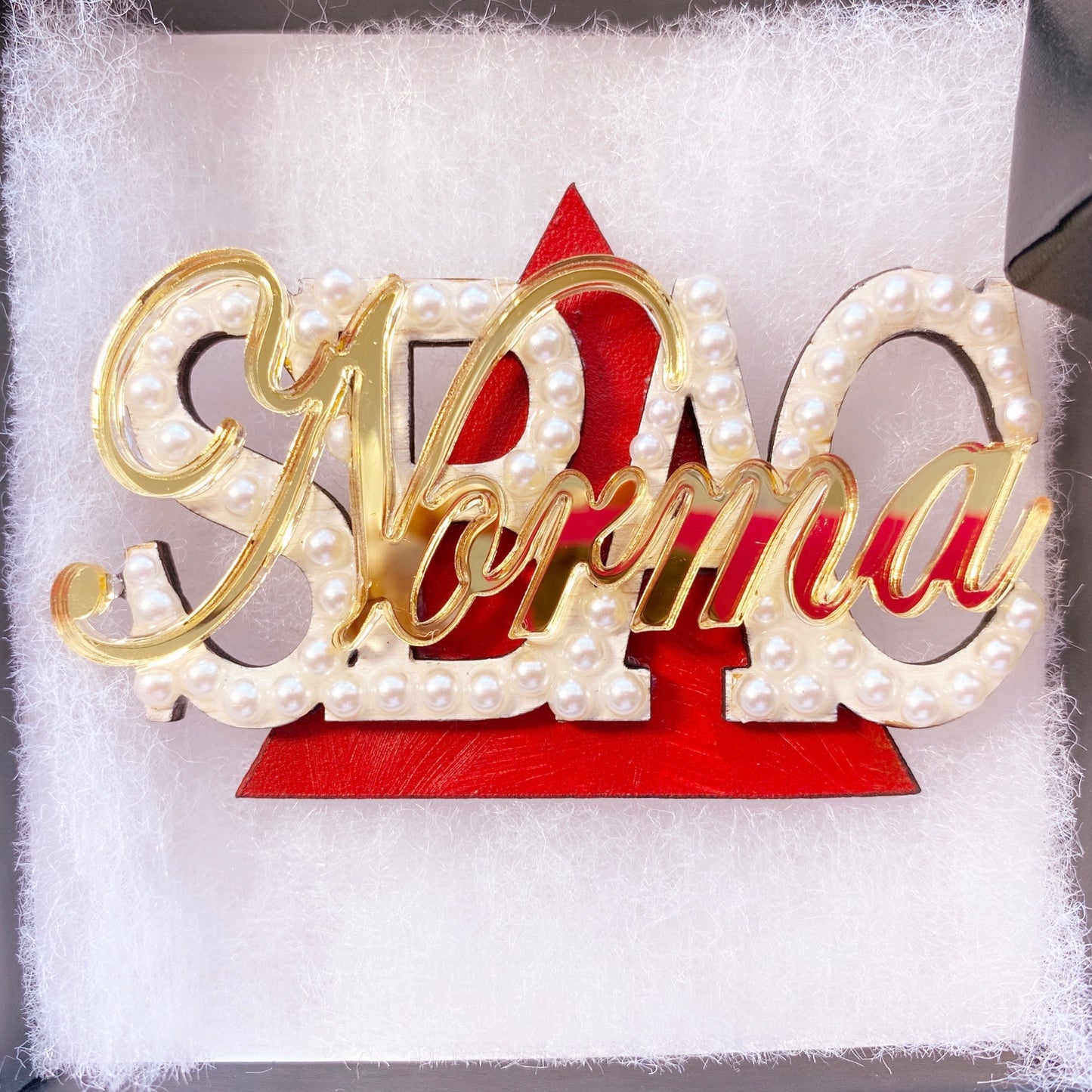 Pearl and red personalized pin with Delta Sigma Theta chapter and name.