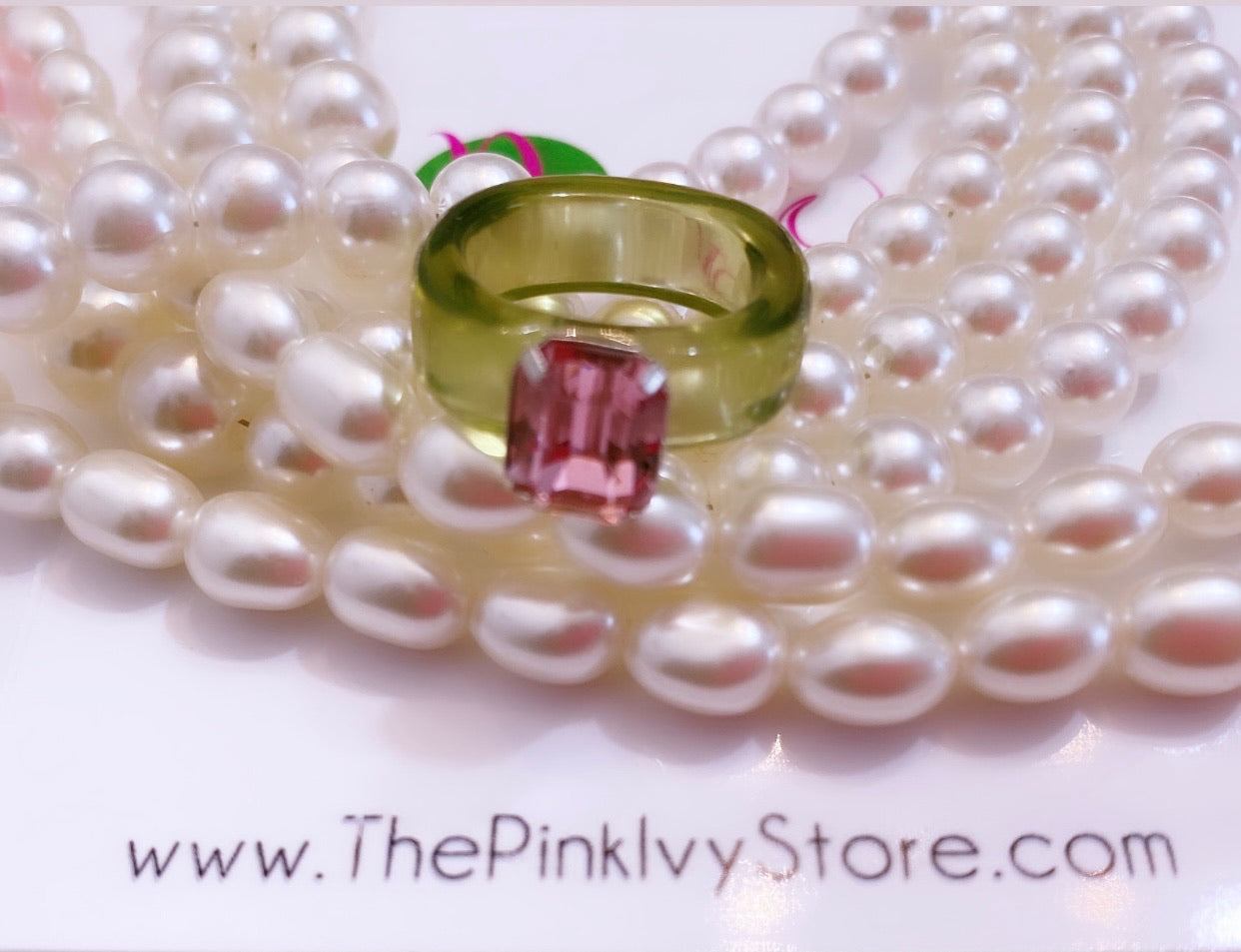 Beautiful green acrylic ring band with pink gem.