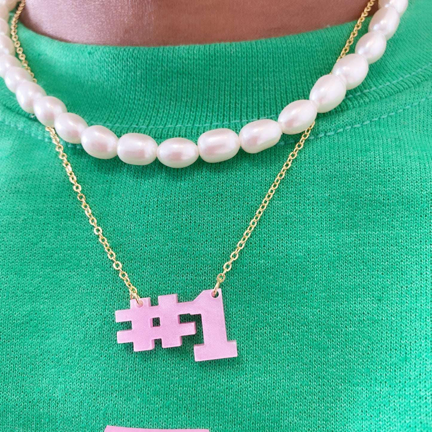 Soror wearing pink line Number 1 necklace for illustrious sorority members. Perfect for sorority anniversary, initiation, and crossing gift.